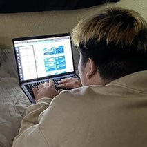 Student browsing on laptop.